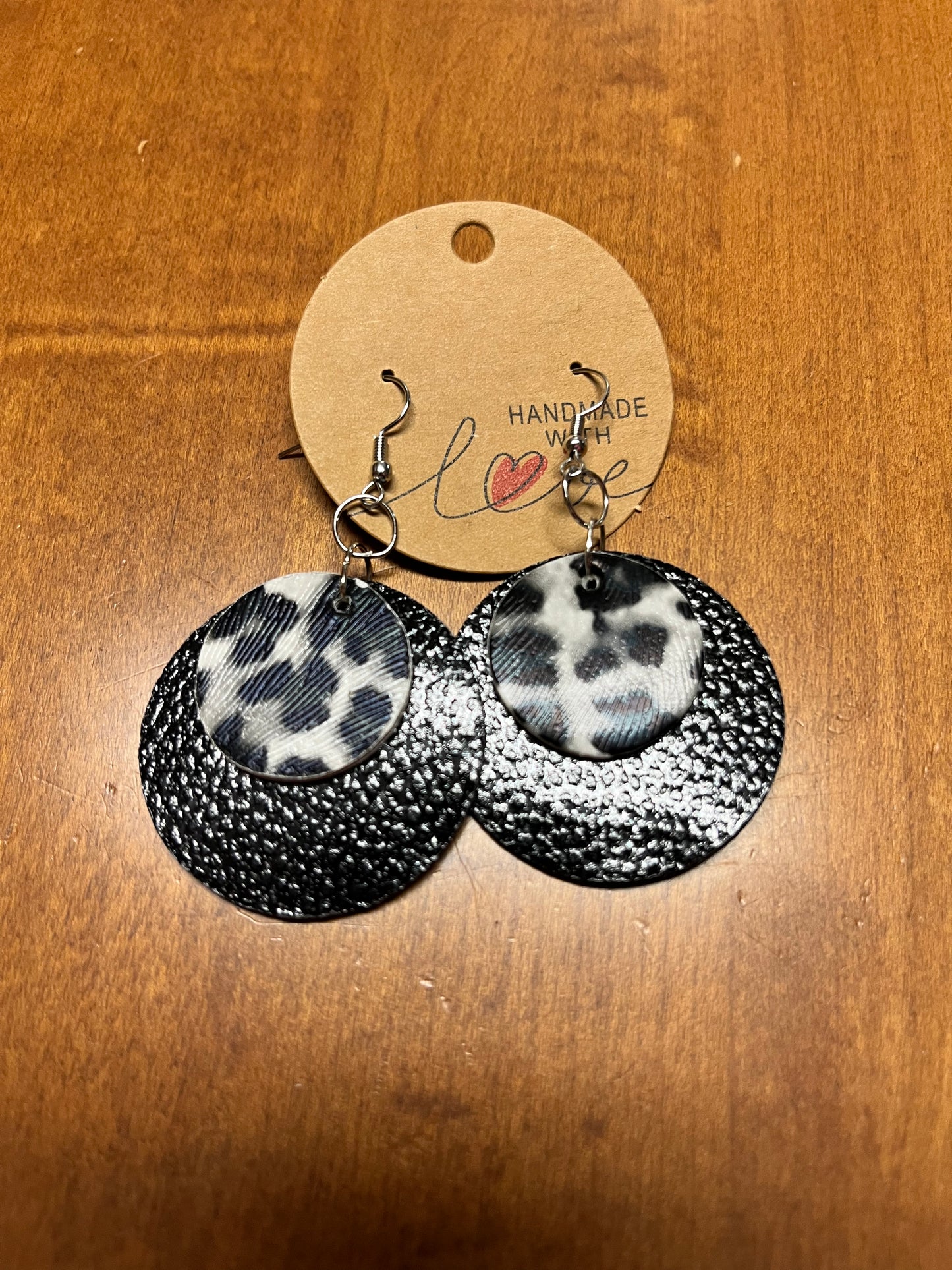 Black faux leather circle shape earrings with white and black leopard print